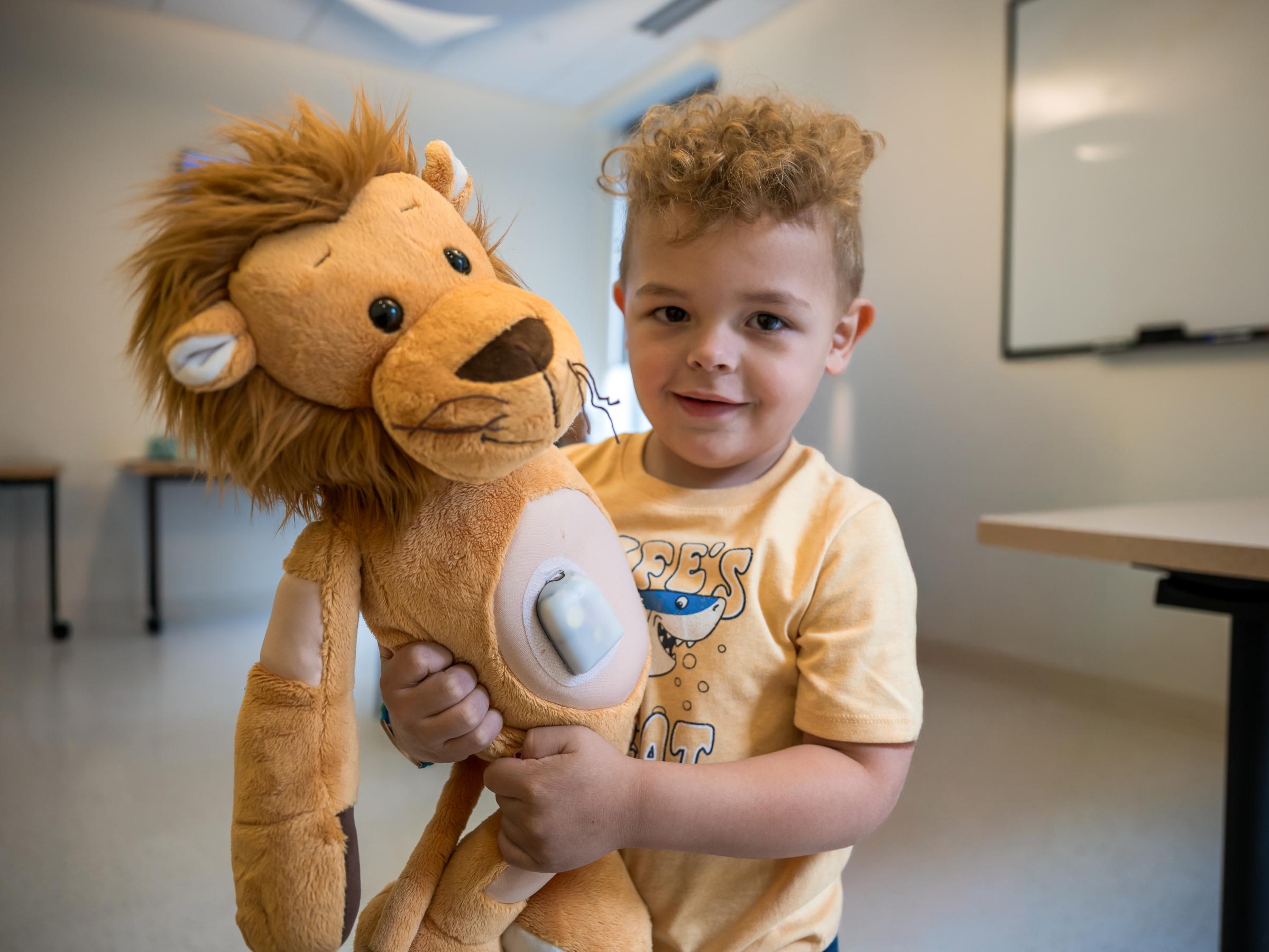 A young boy holding a stuffed animal