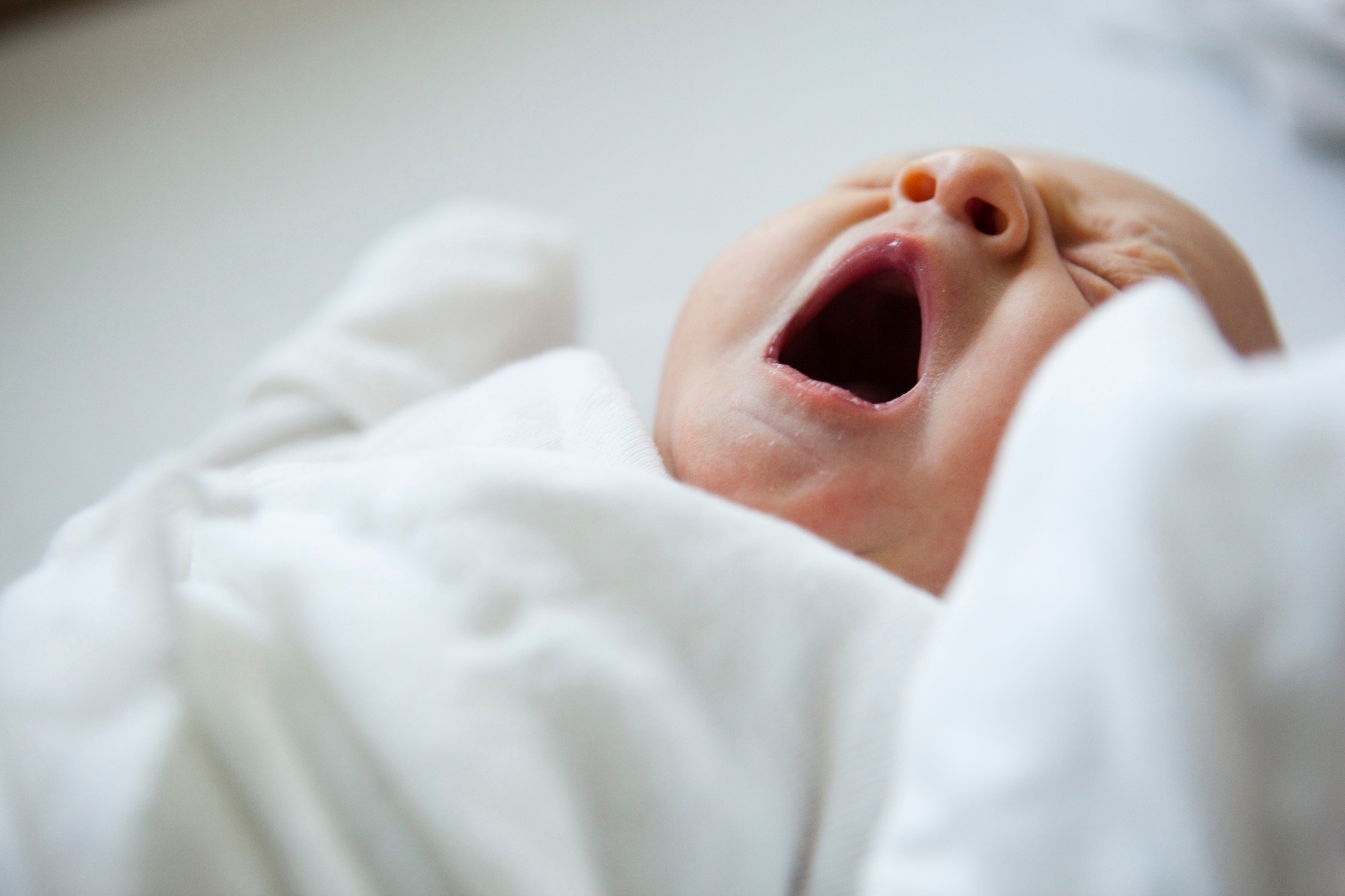 Newborn baby has a big yawn