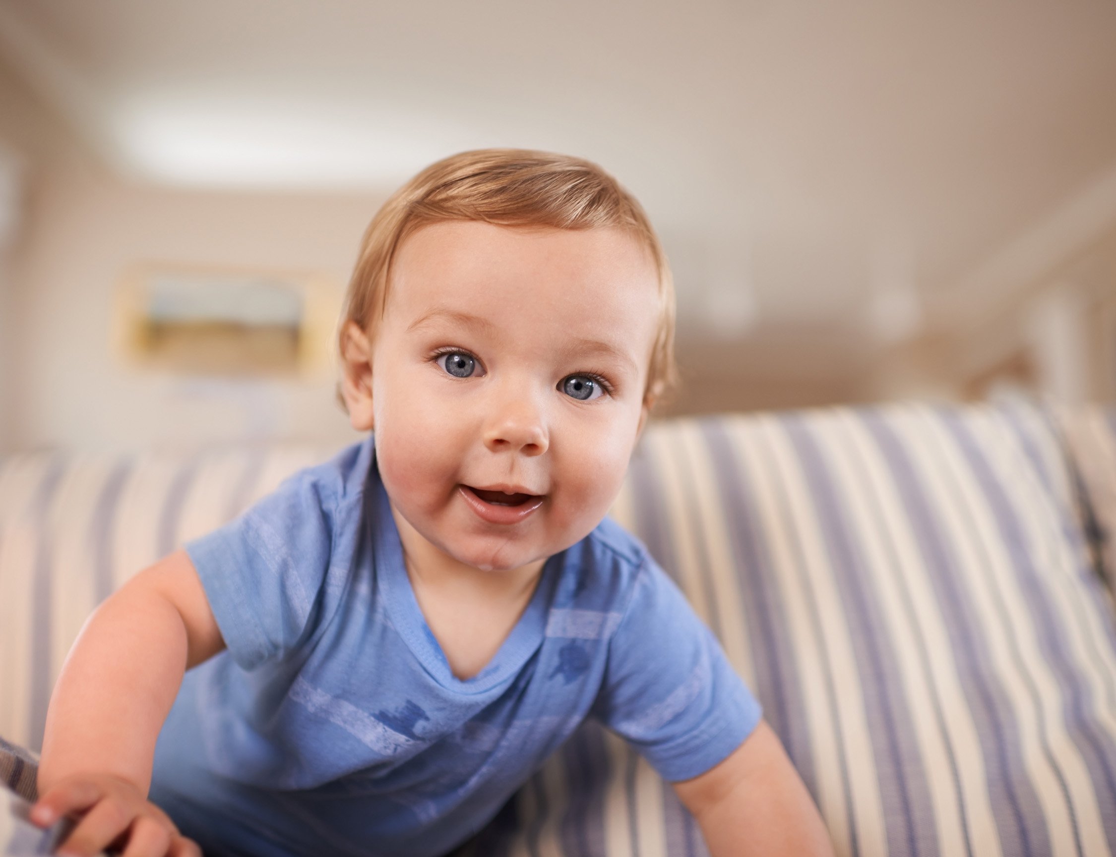 inquisitive child looks at camera while doing tummy time
