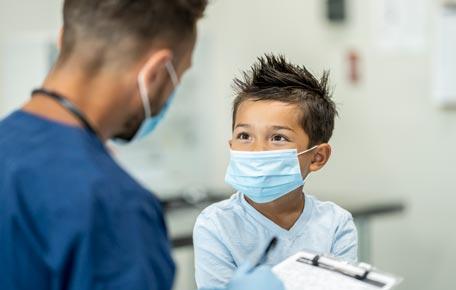 Surgeon comforts child on way to surgery