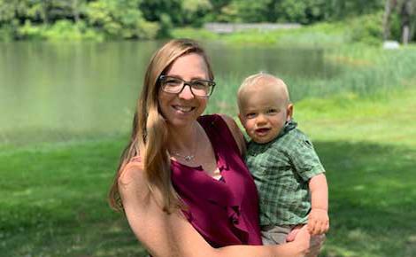 Sammy Wicks being held by his mom. He is the youngest person to get a Melody valve.