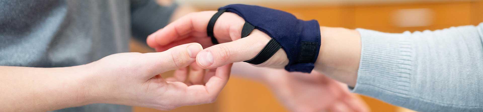 A patient getting help with handle muscles in a clinic 