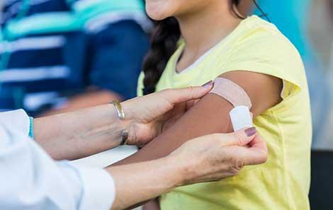 a child getting an HPV vaccine to prevent cancer