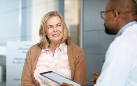 A female patient talks to her doctor about Mohs surgery for skin cancer.
