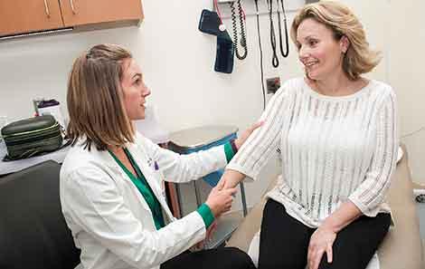 A woman consults with her provider about joining a clinical trial for cancer treatments