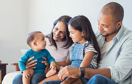 Happy Family sitting on a couch