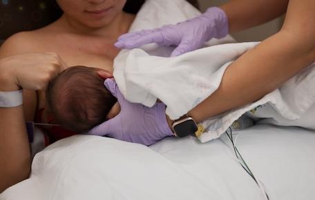 Lactation consultant helps new mom with latch