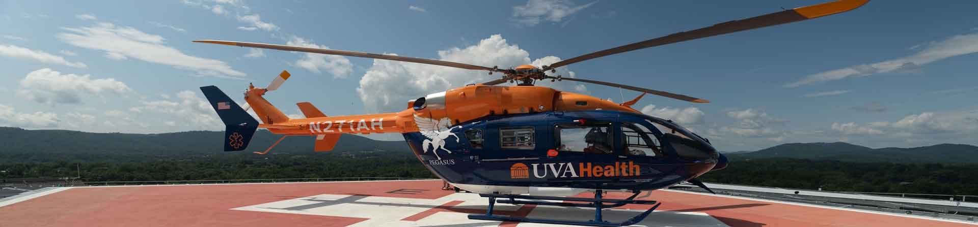 A blue and orange medical rescue helicopter with a white pegasus on the side