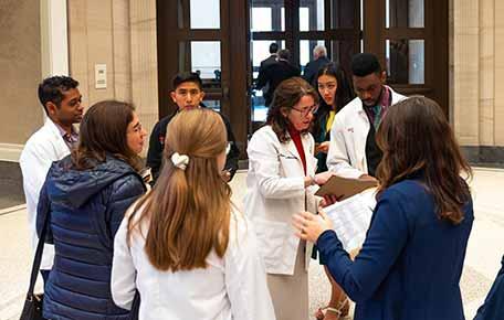 Faculty and students reviewing materials together