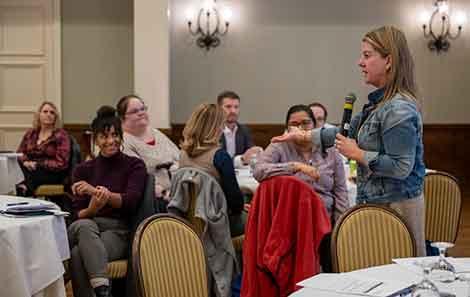HLI participants working together as a group and listening to a speaker