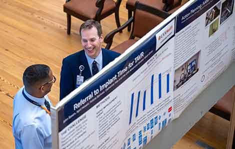 Two HLI participants looking at a presentation