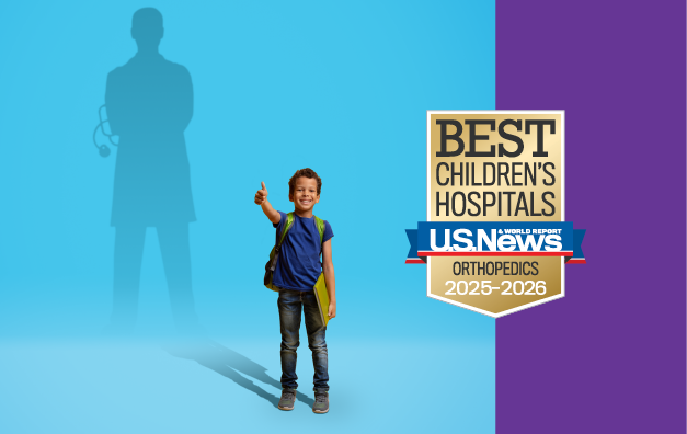 Young boy stands in front of blue background and imagines future self as a doctor