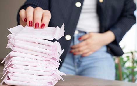 Teenage girl reaches for menstrual pad