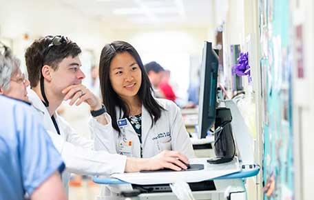 Doctors look at a computer together