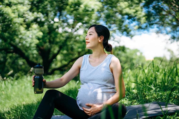 Pregnant women stretching in the outdoors