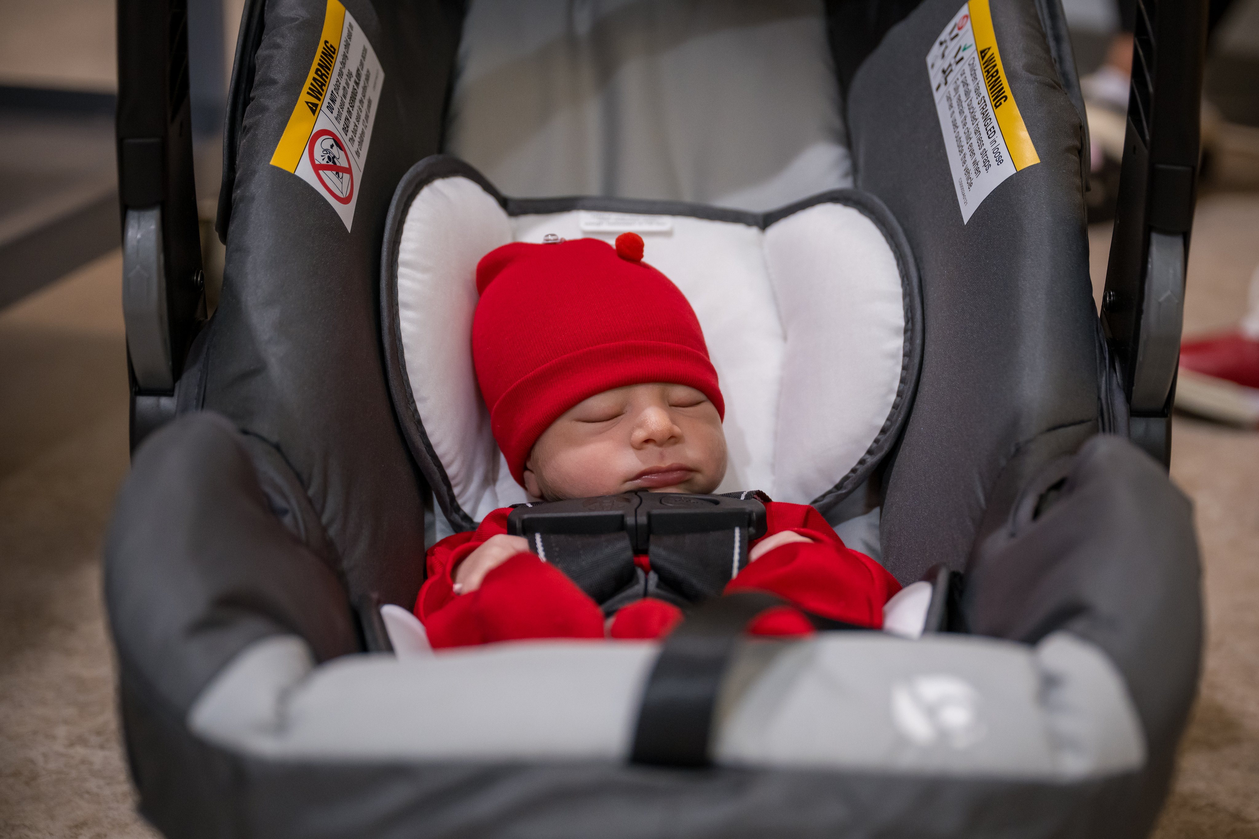 baby safely sleeping in real car seat