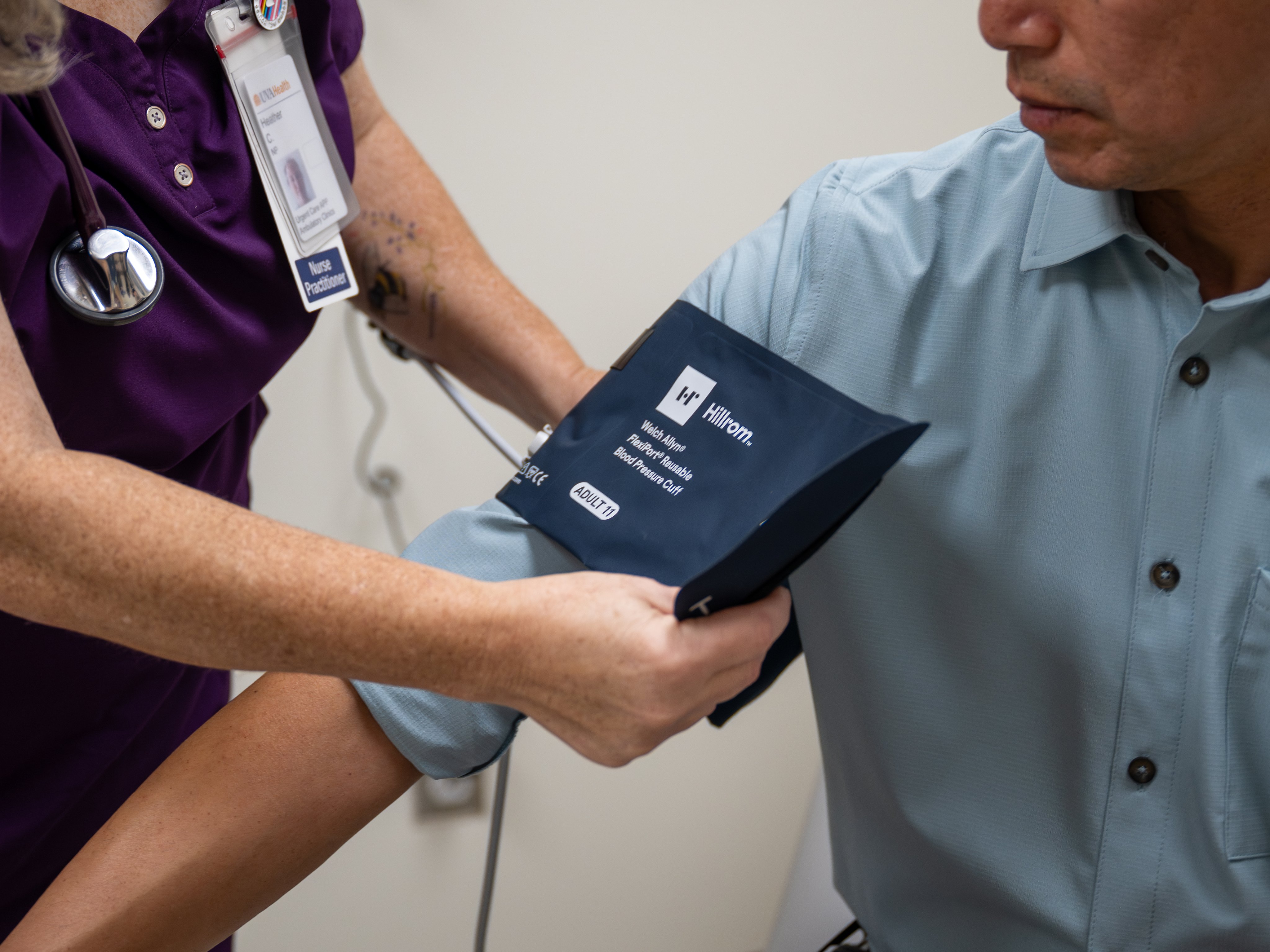 FNP checking patient vitals in exam room