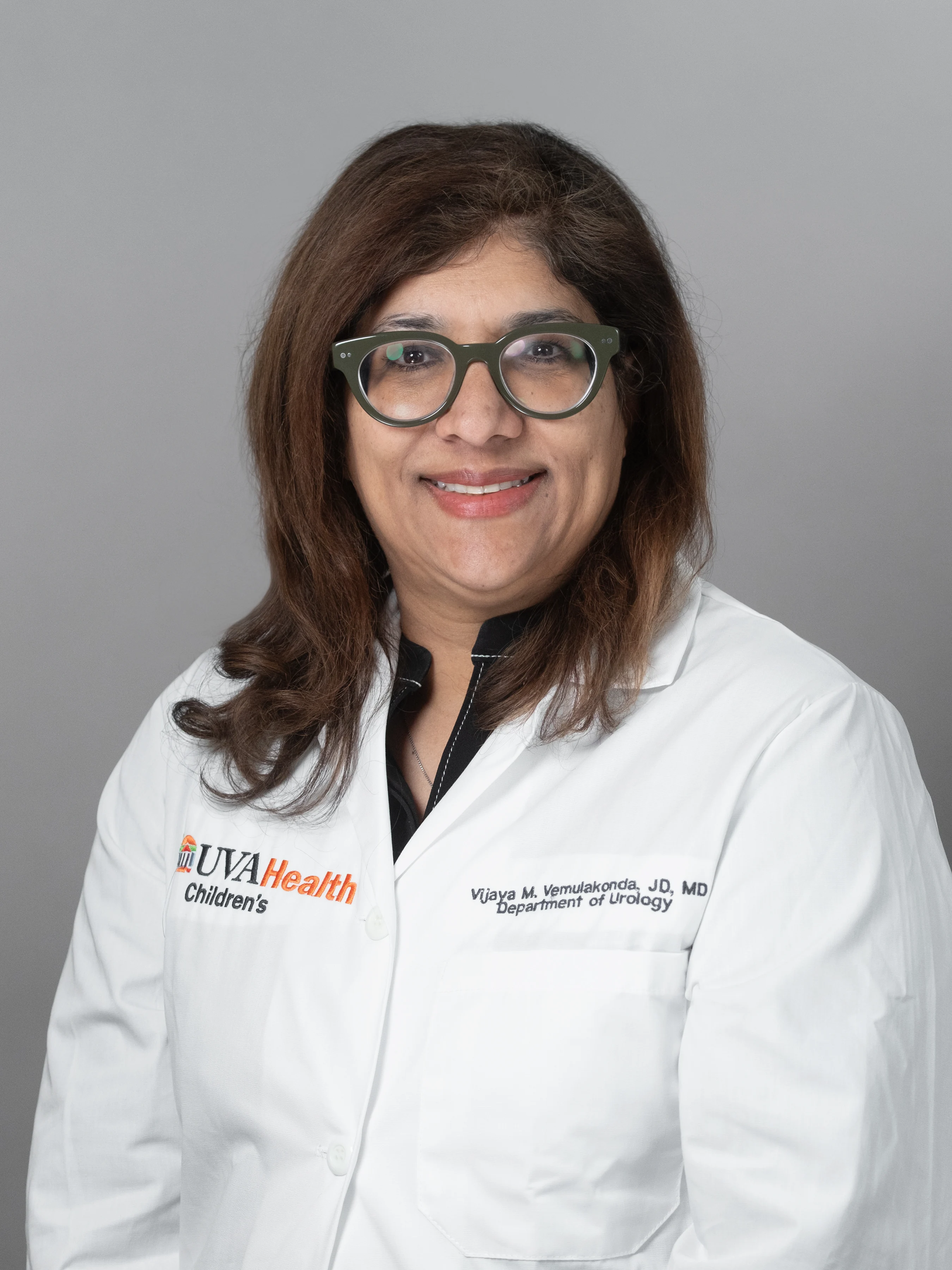 Dr. Vemulakonda smiles in a UVA Health Children's white coat