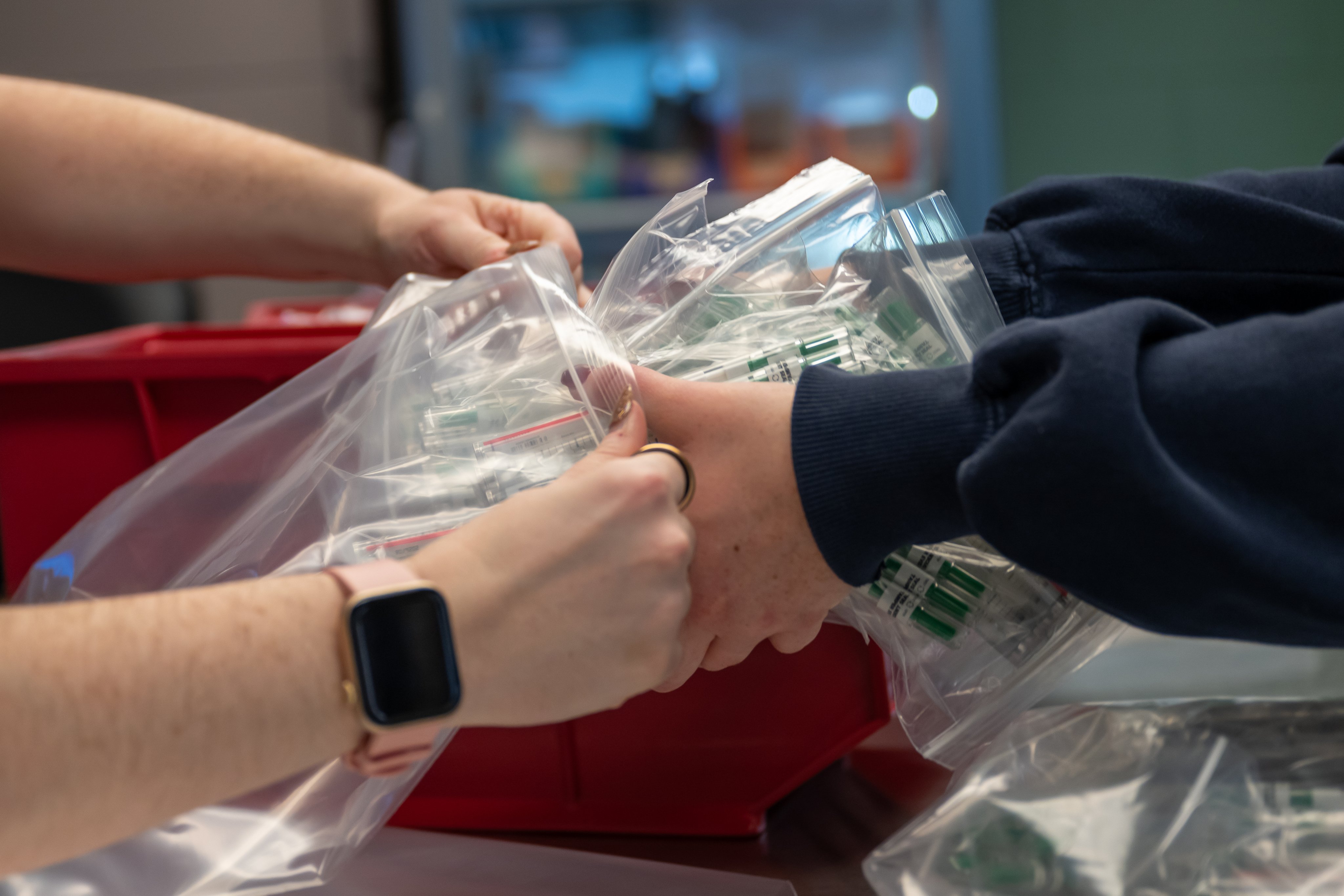 pharmacists handing medication to patient with care