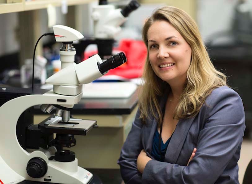 Tajie Harris at a microscope