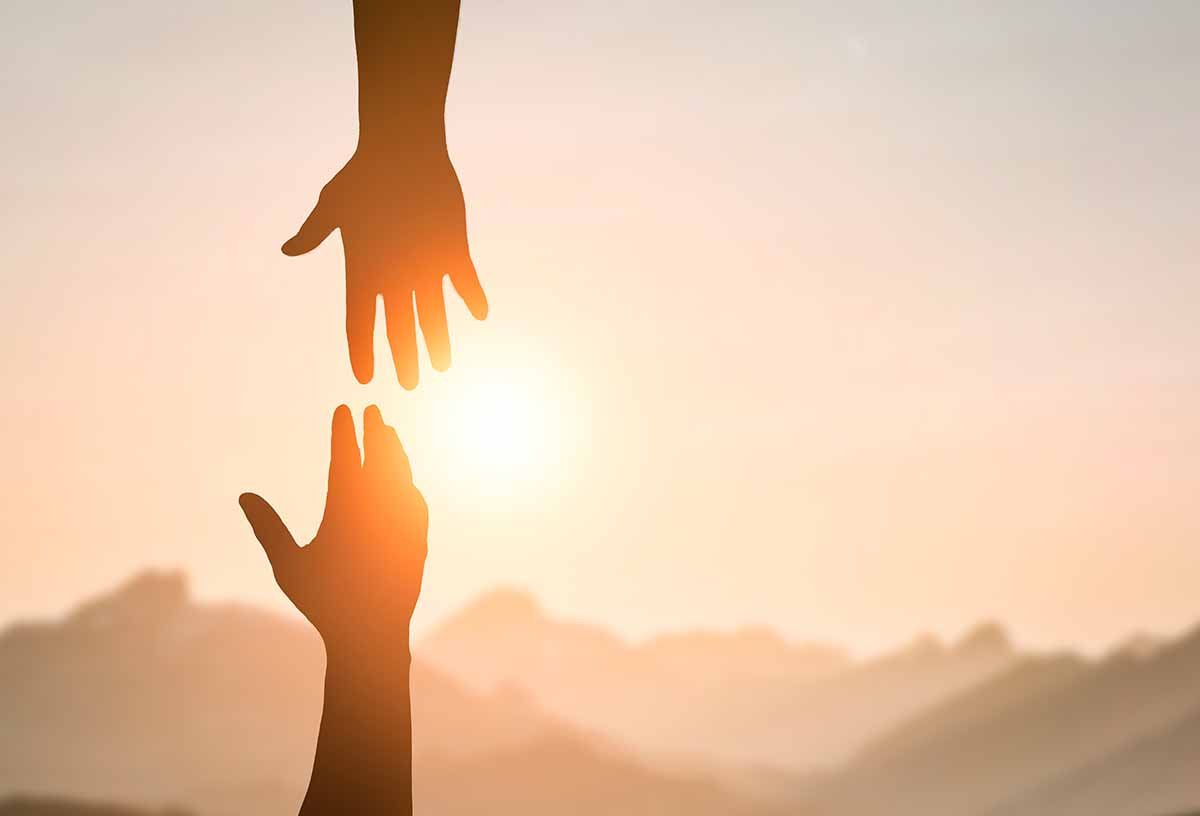 Hands reaching toward each other