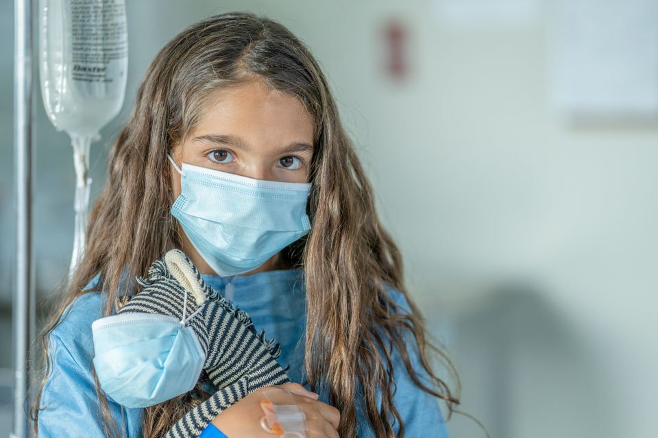 Little girl with mask and IV waiting for liver transplant from domino procedure