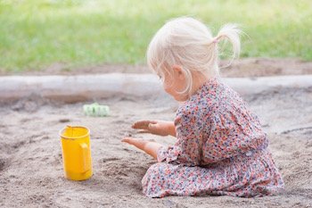 Child plays in sandbox