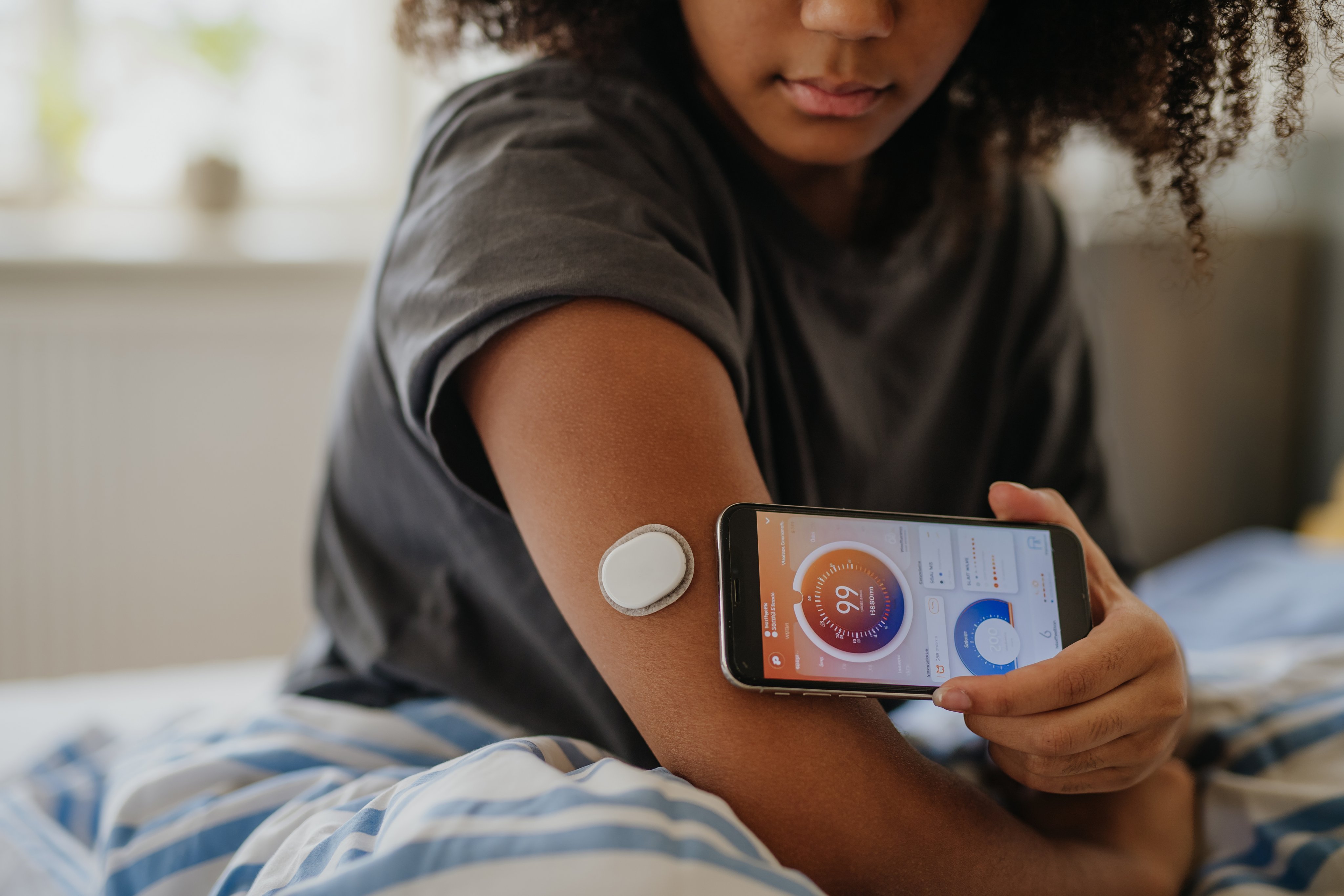 Teen girl connects glucose monitor to smart phone