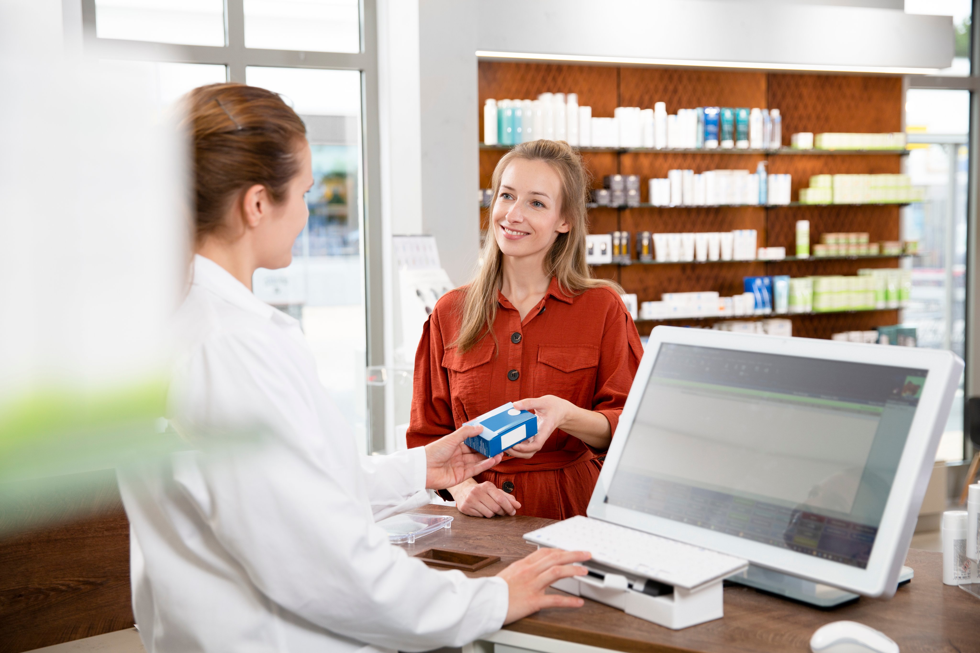 Pharmacist gives medicine to woman