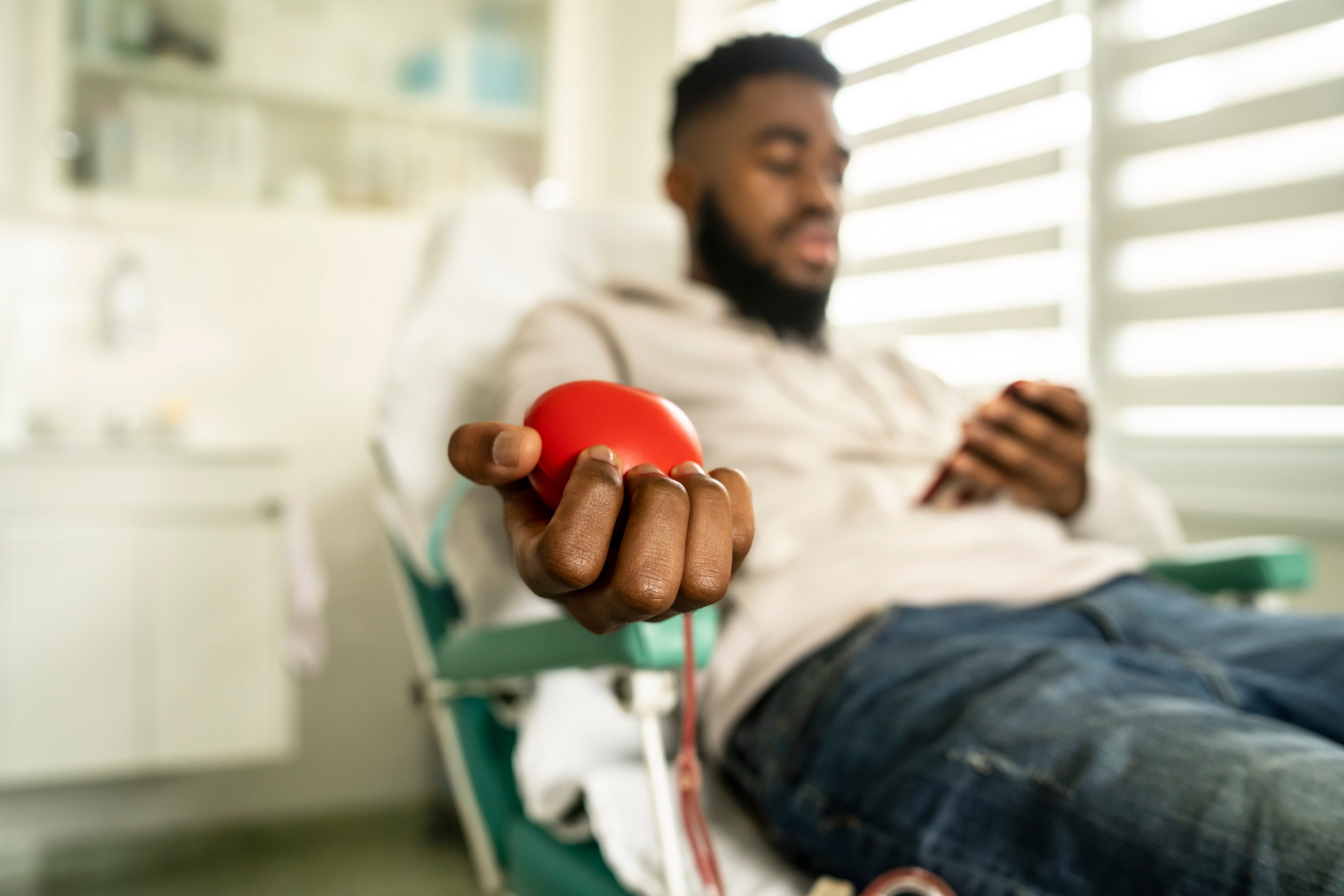 Patient squeezes ball while giving blood