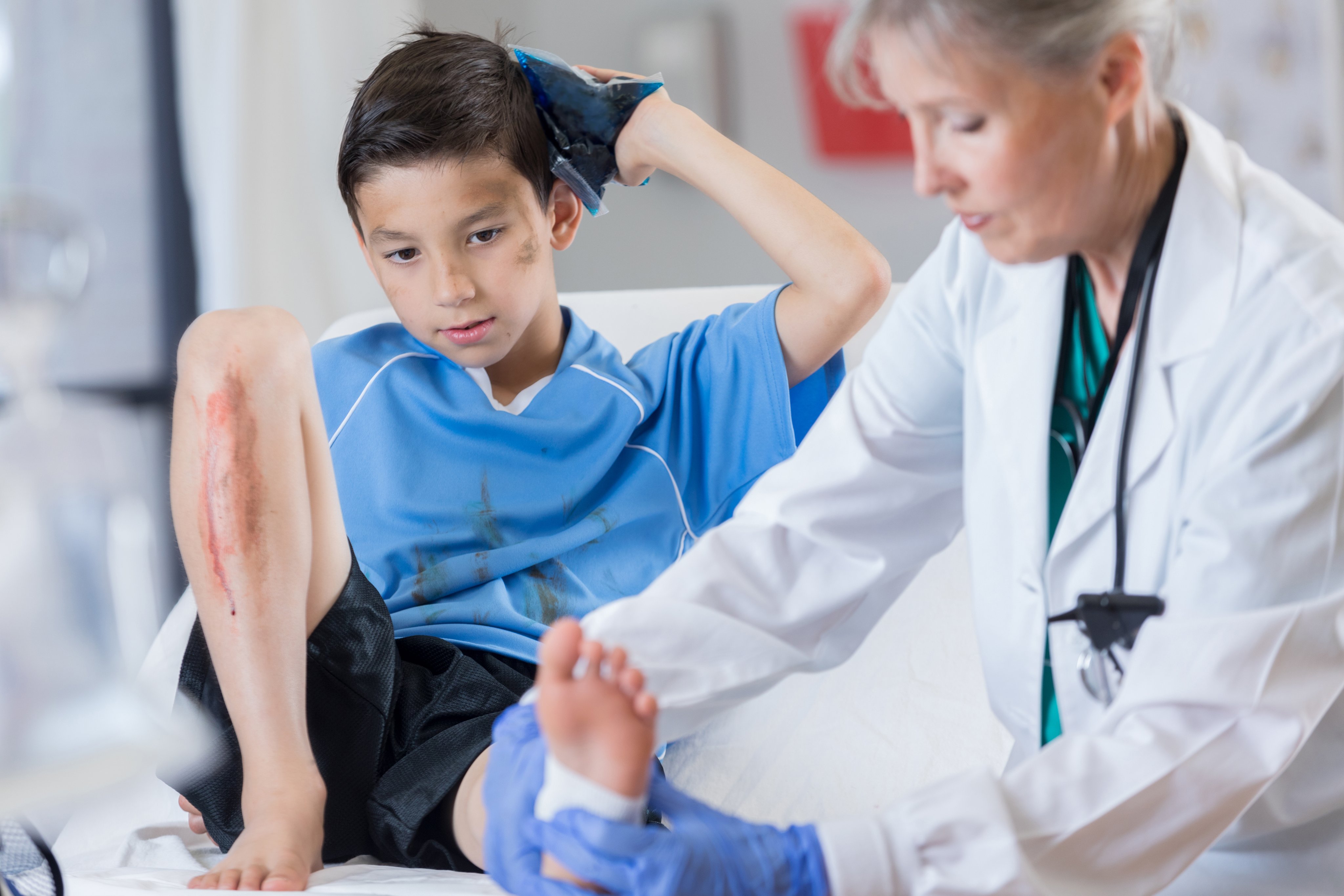 Young boy in sports uniform is seen in emergency room