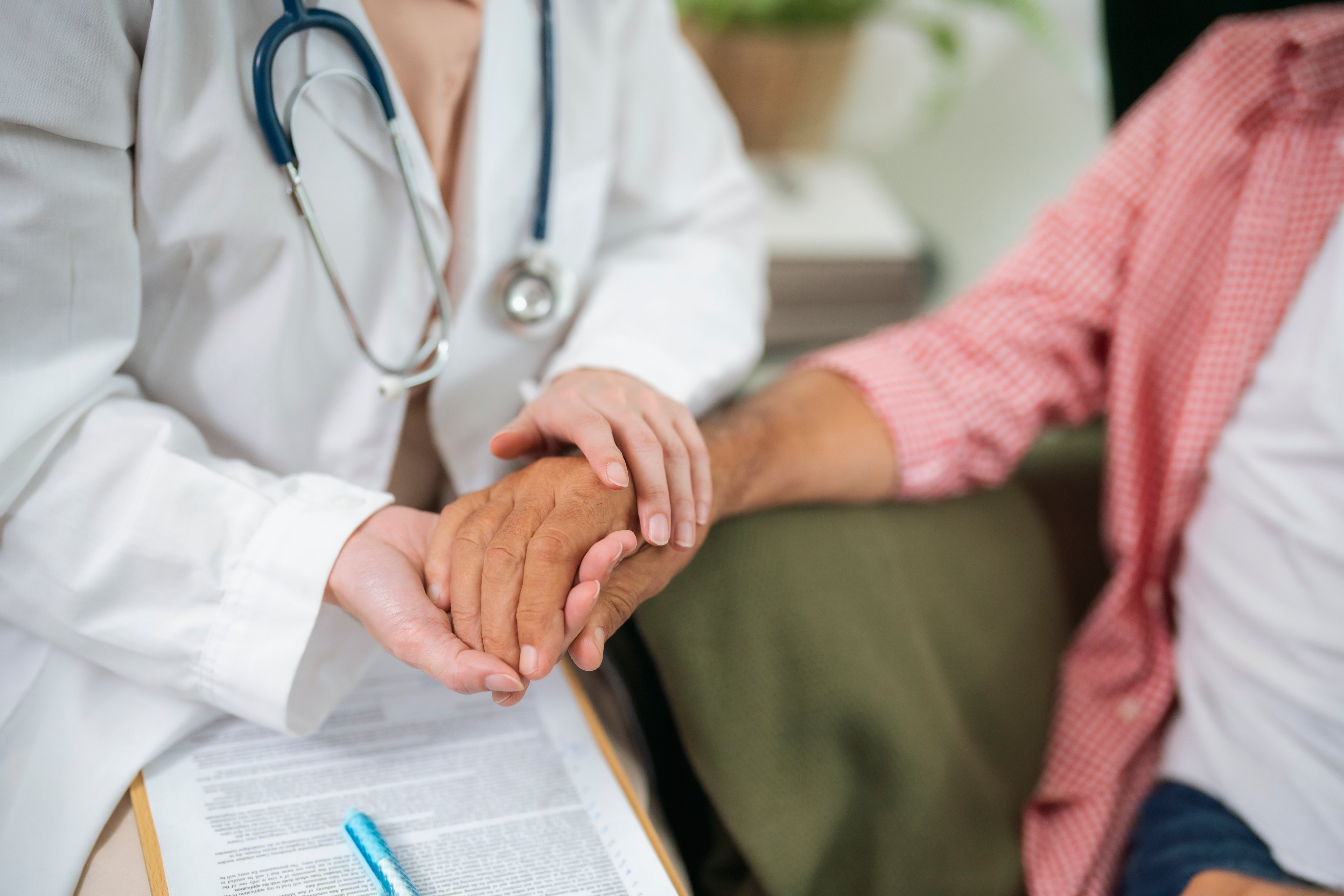 A doctor comforts a patient