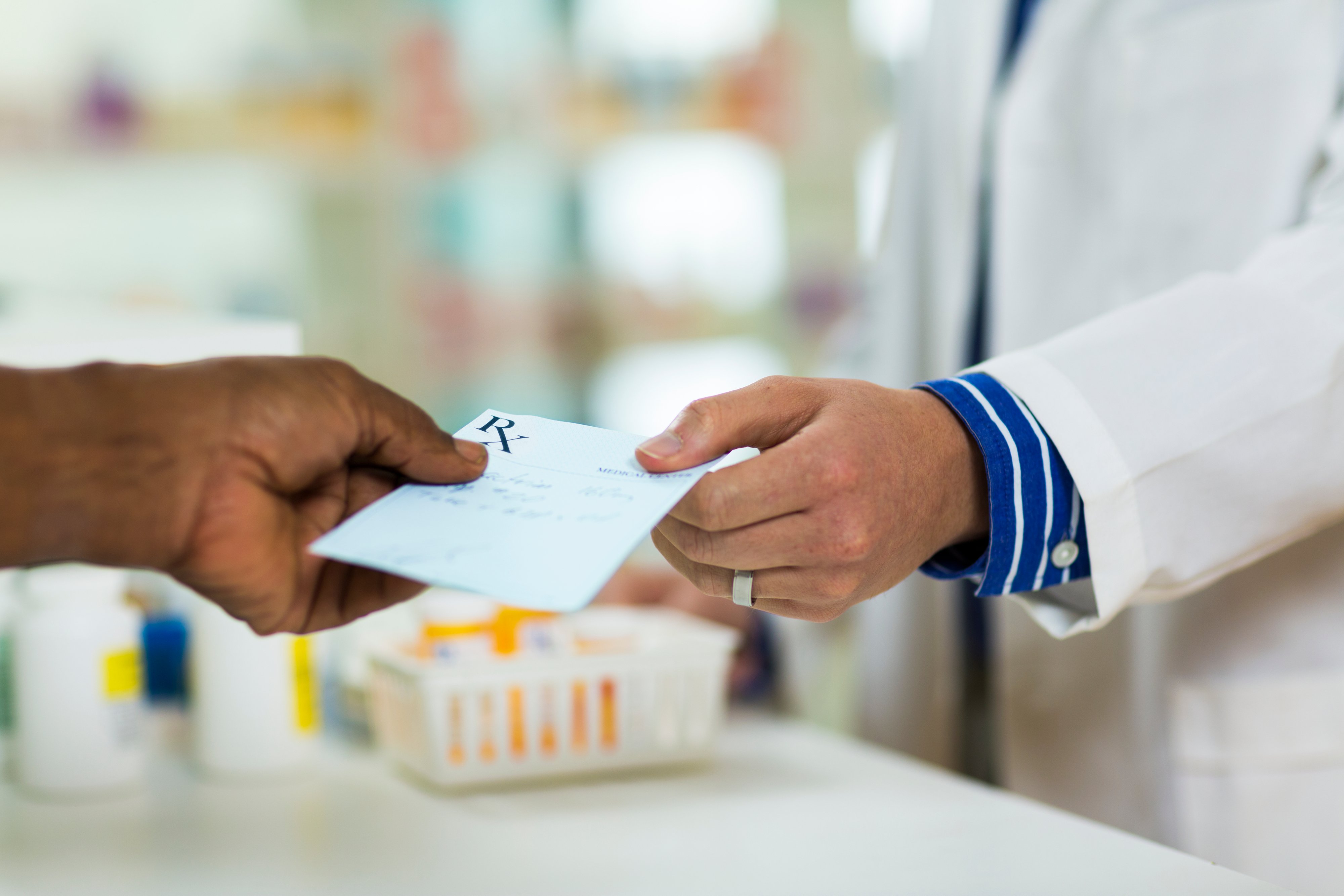 doctor hands patient a prescription
