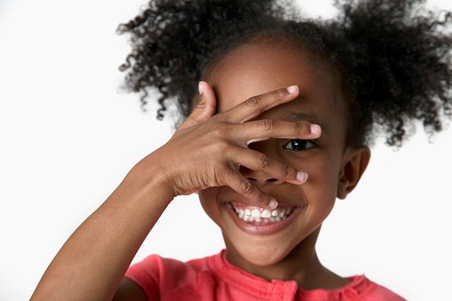 Child peeking through fingers