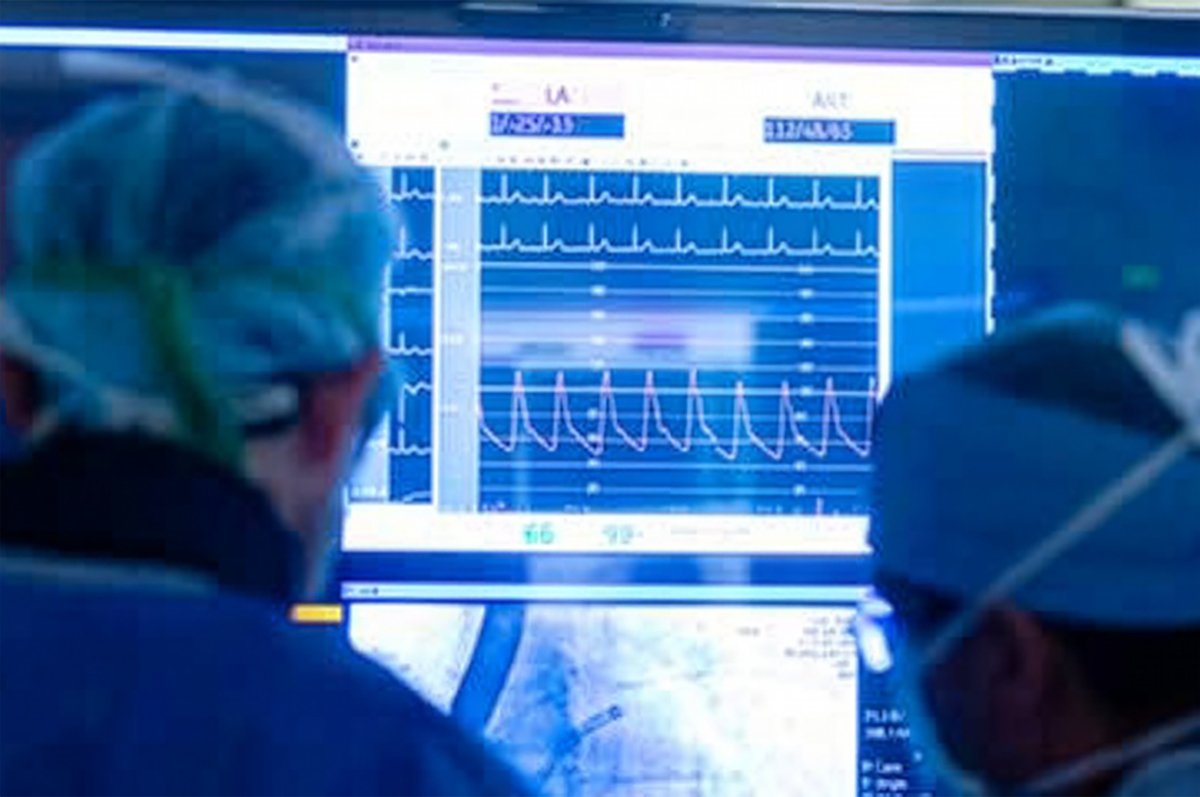 Two healthcare providers looking at a screen with heart & vascular data