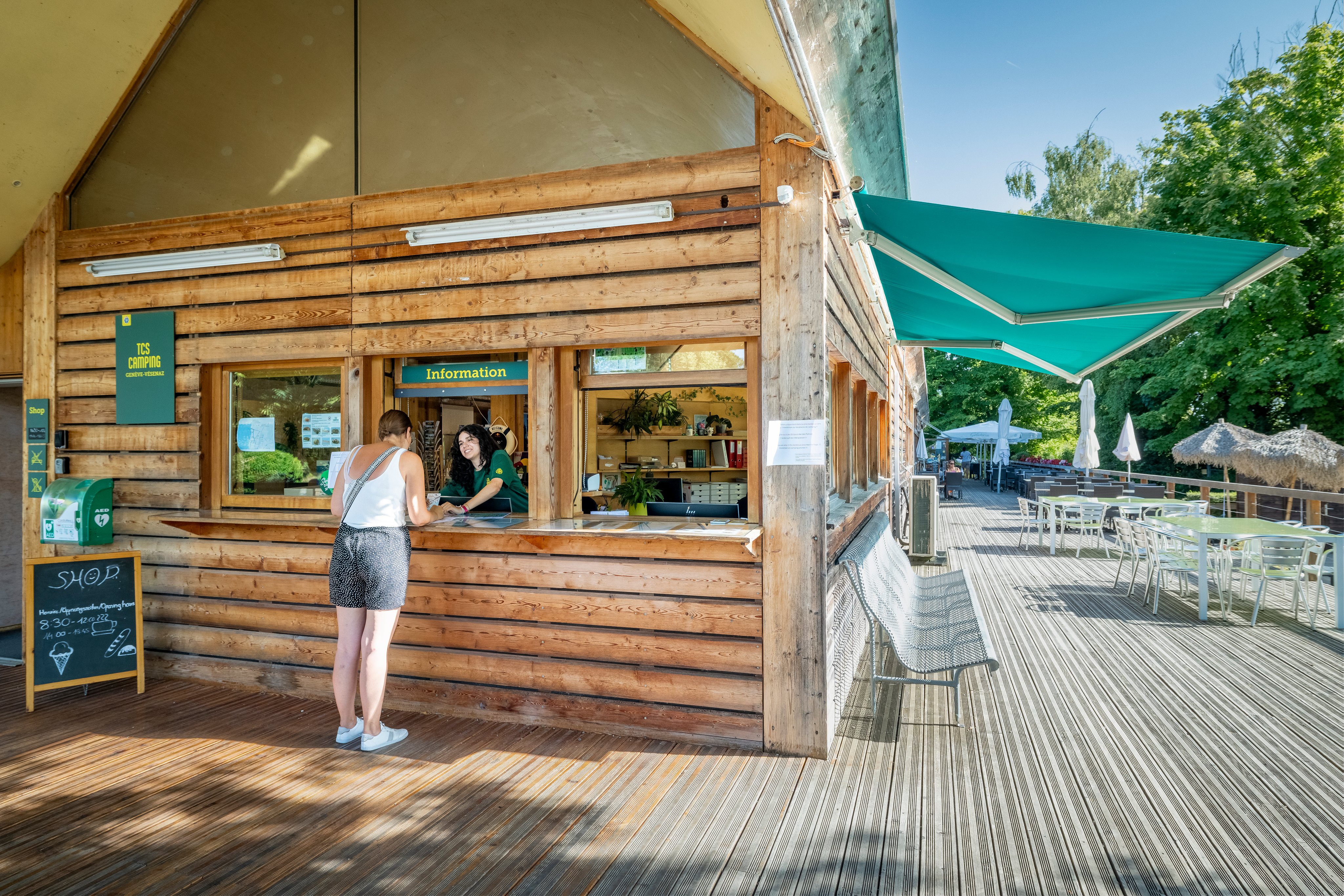 Two young women at reception on a campsite.