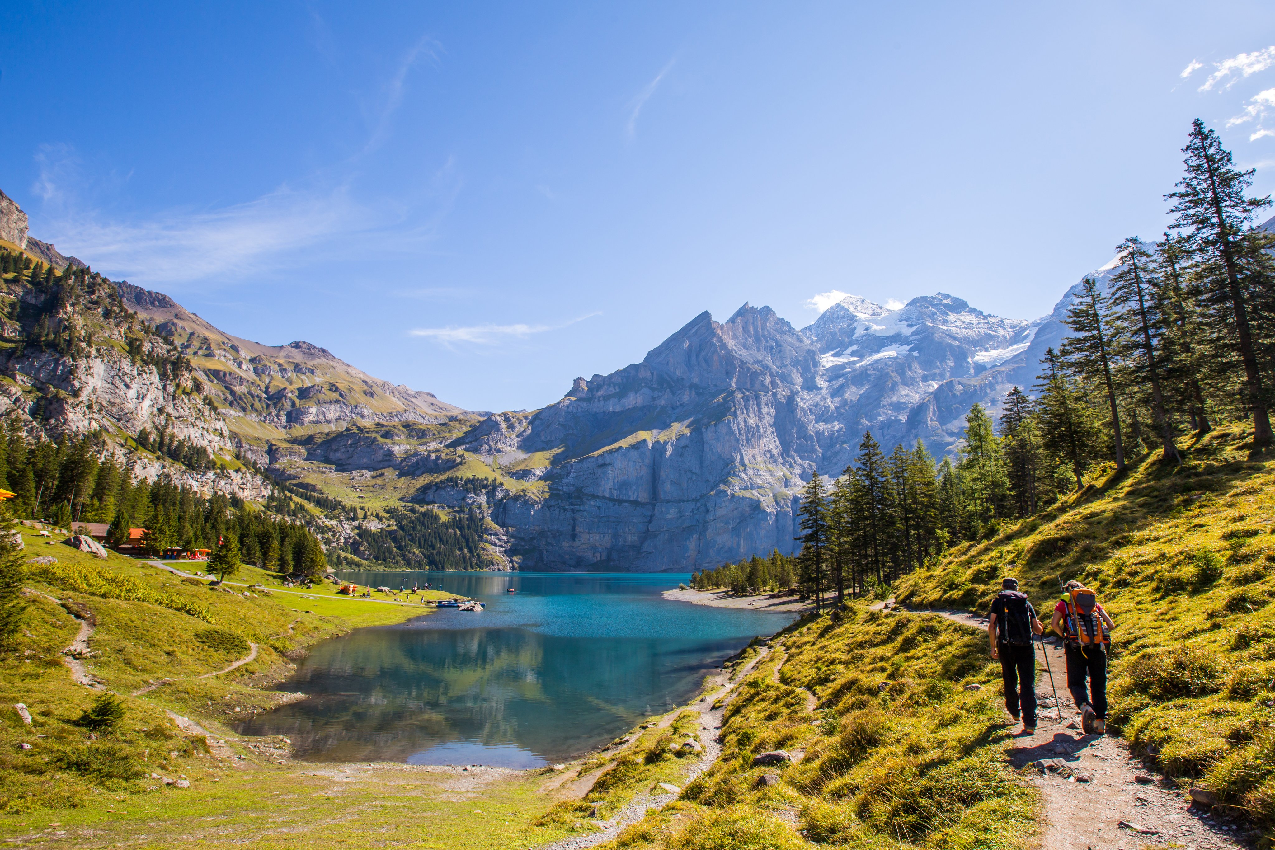 Two hikers at Lake Oeschinen.