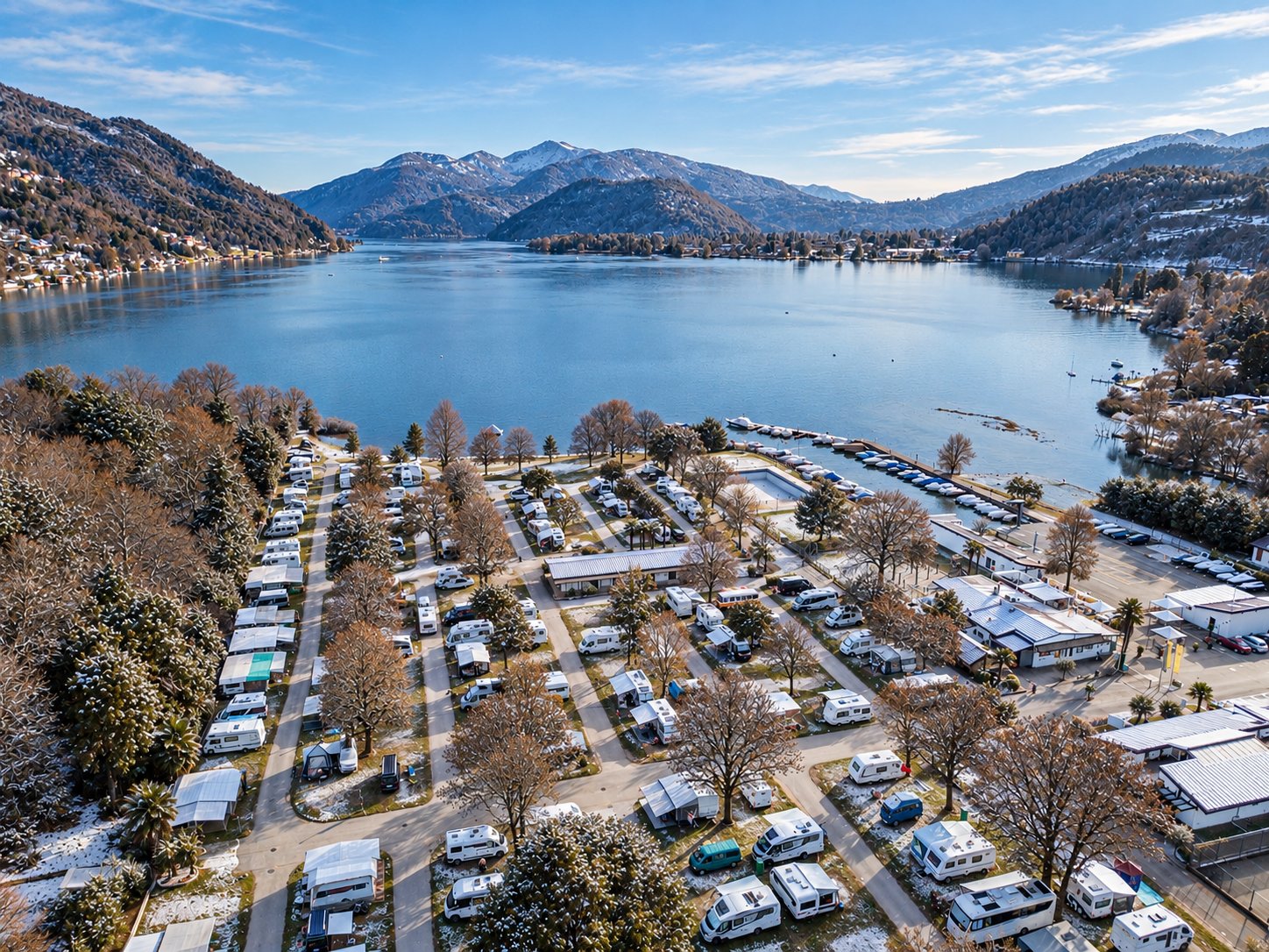 A view from above of the campsite in winter, right by a lake