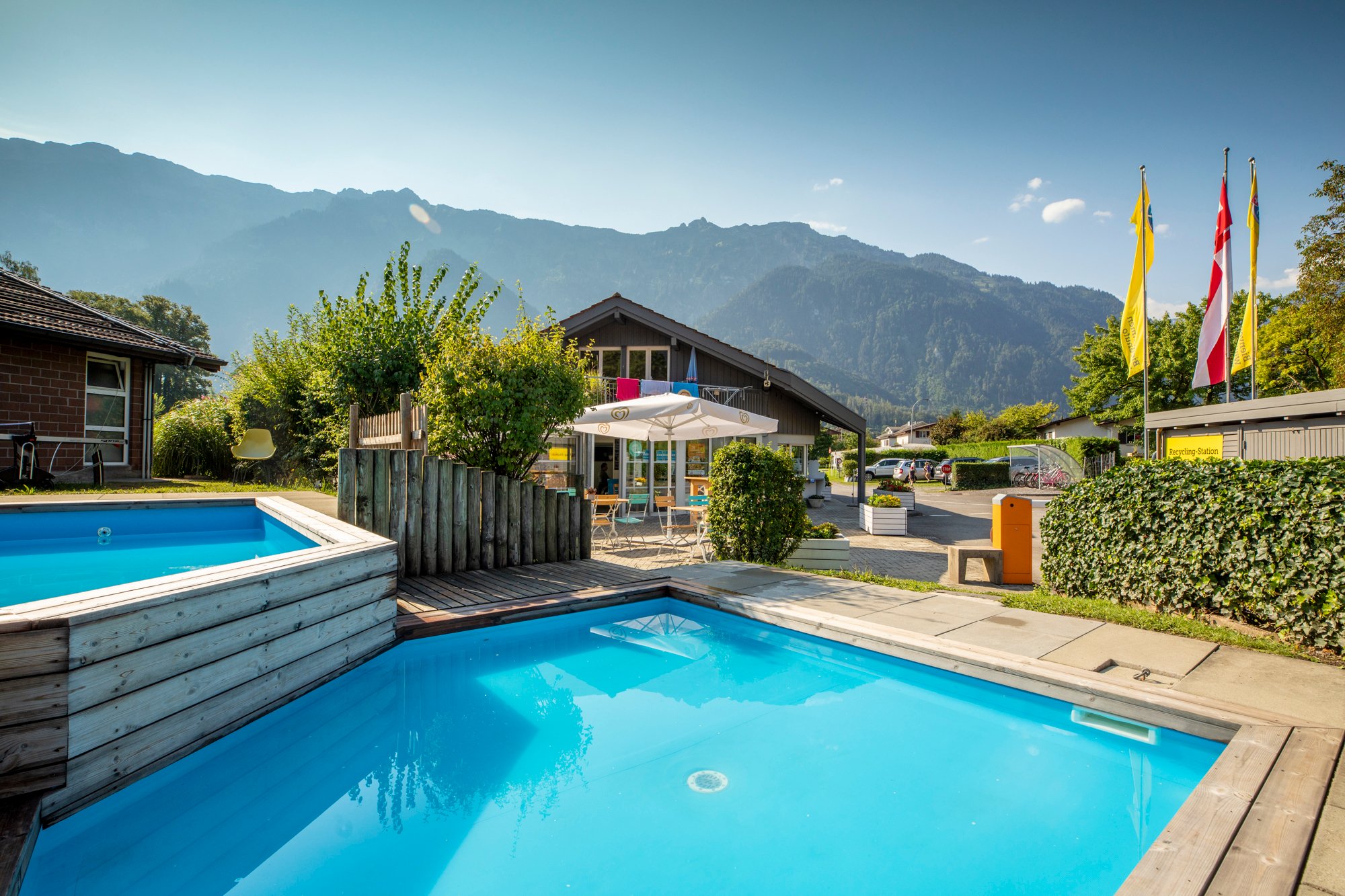 Children's pool on a campsite, with mountains in the background.