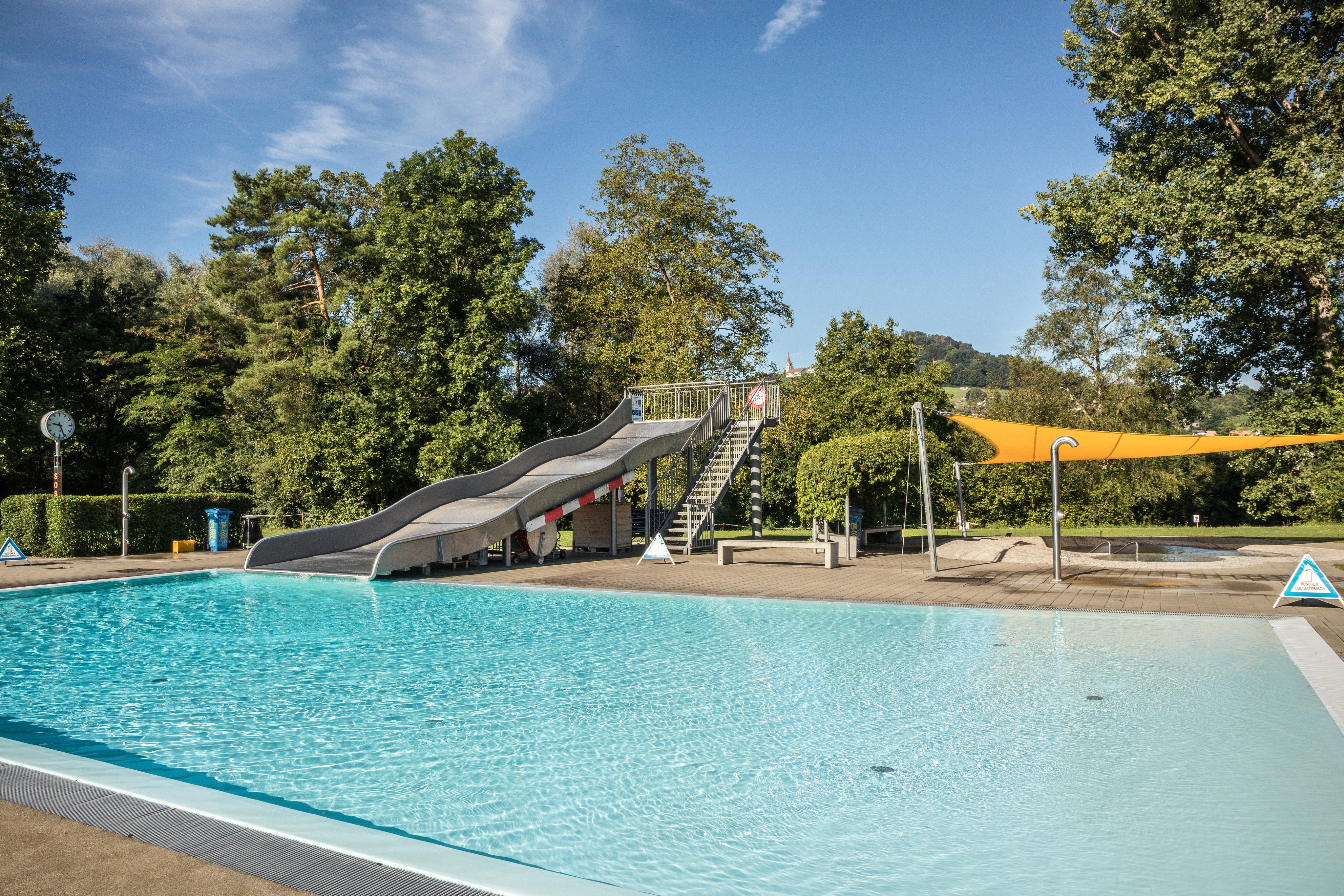 Outdoor pool with slide at TCS Camping Flaach am Rhein.