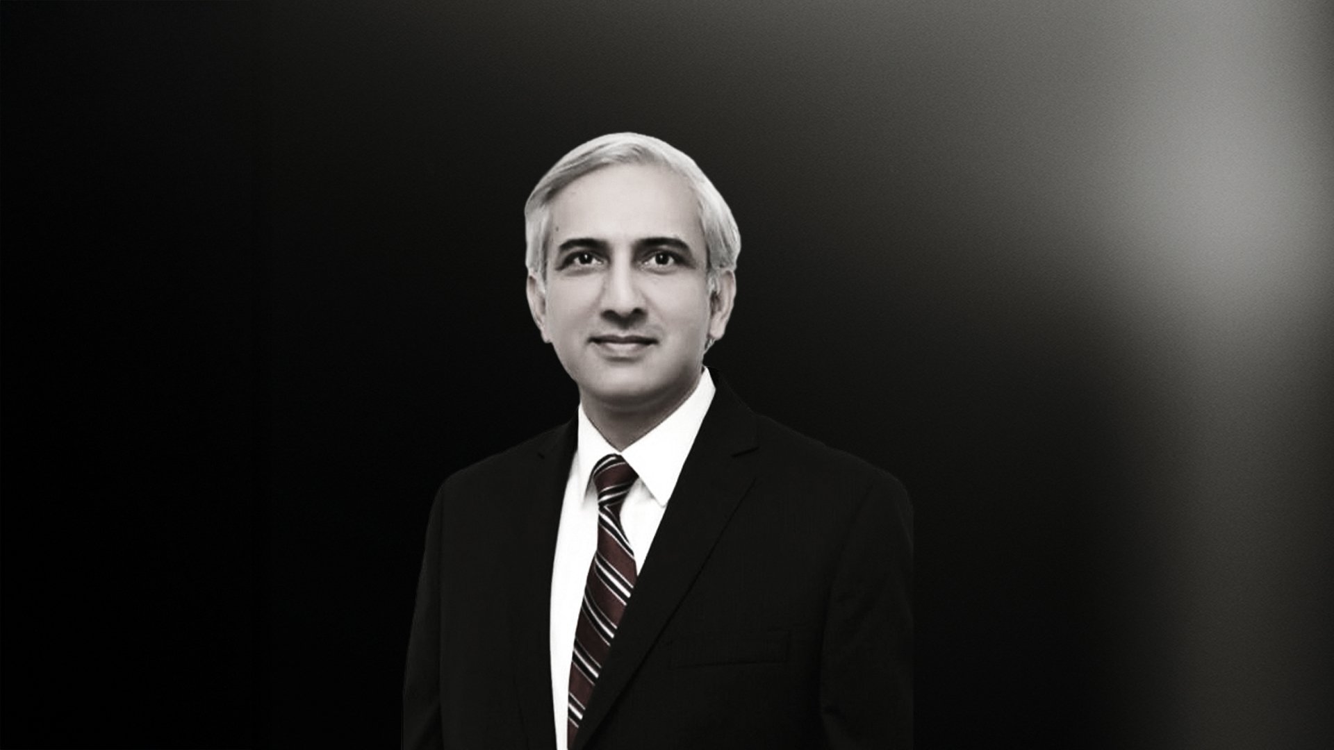 professional portrait of Prof Muhammad Moin in formal attire against a dark gradient background