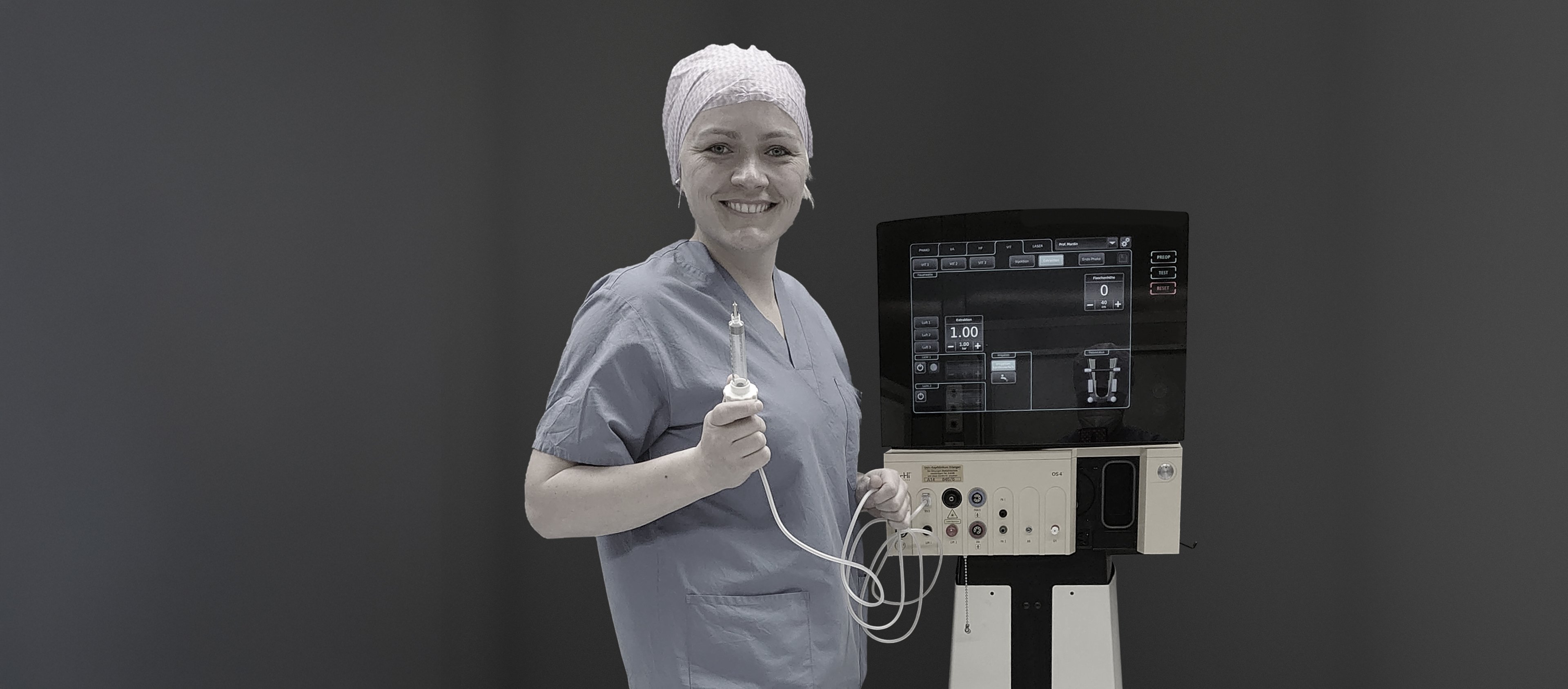Portrait of a smiling surgeon in the operating room holding an instrument beside an ophthalmic device by Oertli