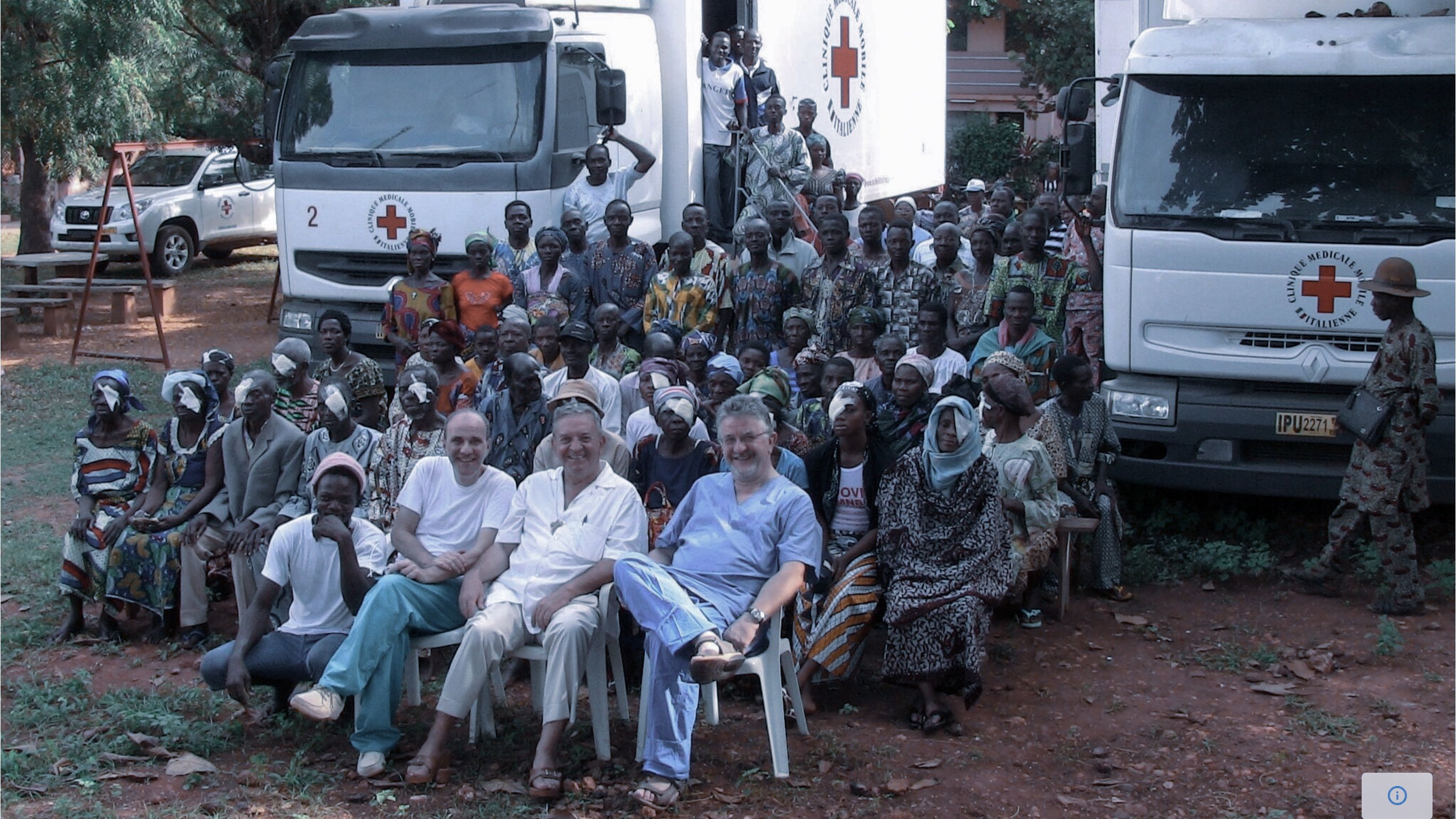 Group photo of patients and medical staff during a Soleil d’Afrique ophthalmic outreach programme with mobile clinic trucks
