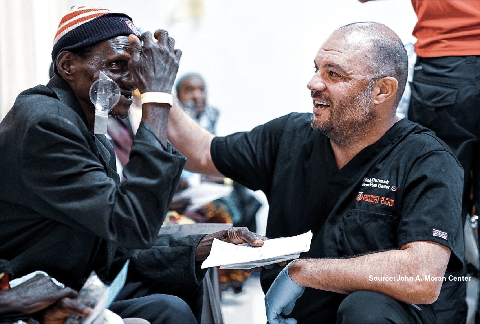 Healthcare professional from the Moran Eye Center speaking with a patient during an eye care outreach programme