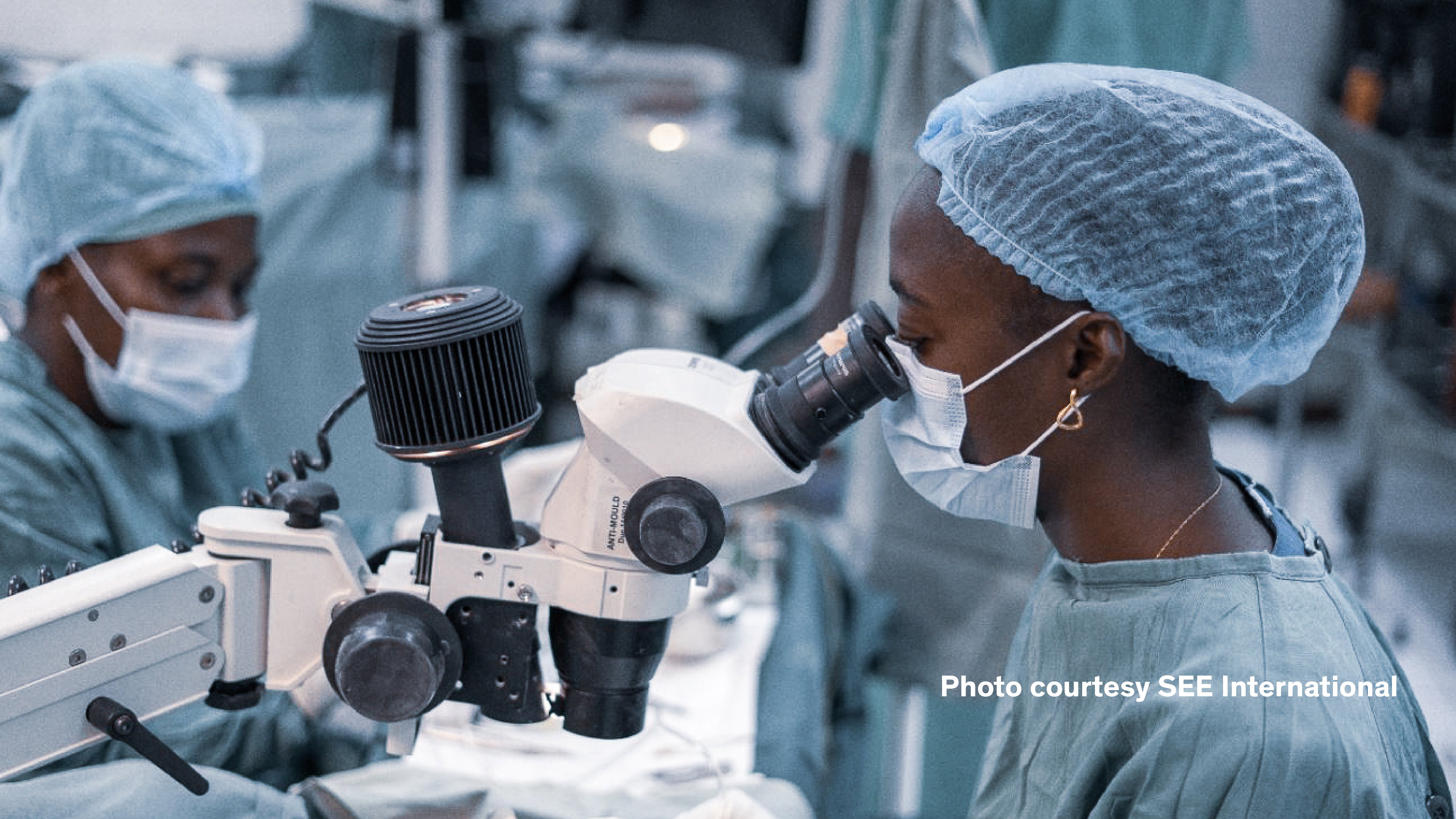 Ophthalmic surgeon using a surgical microscope during an eye surgery procedure in an operating room