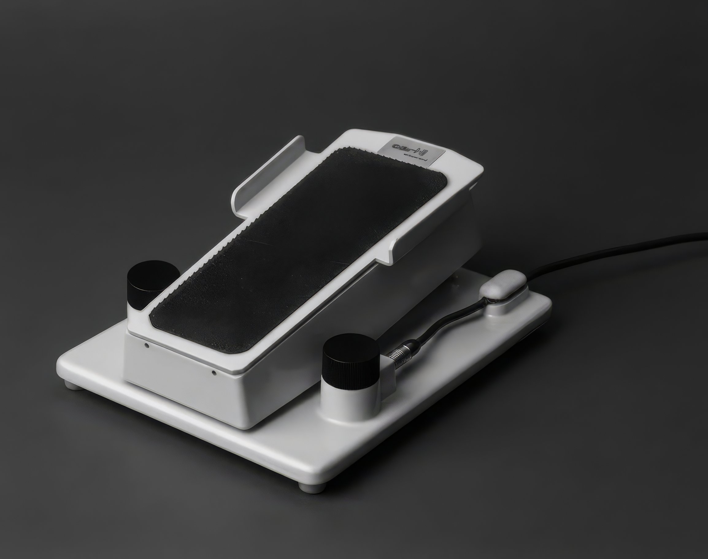 Historical Oertli foot pedal shown on a dark background