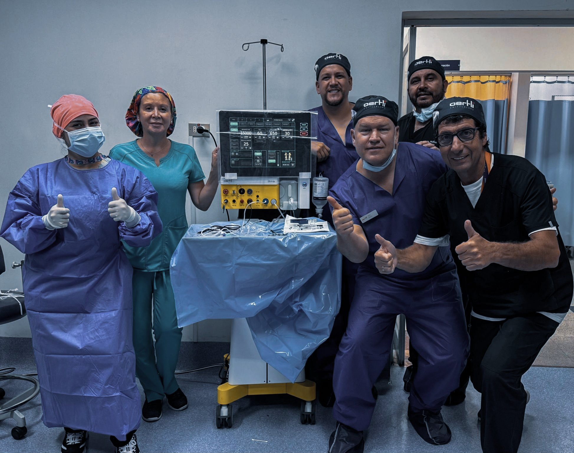 Smiling and happy surgical team in Chile posing with the OS 4 Up surgical platform in an operating room