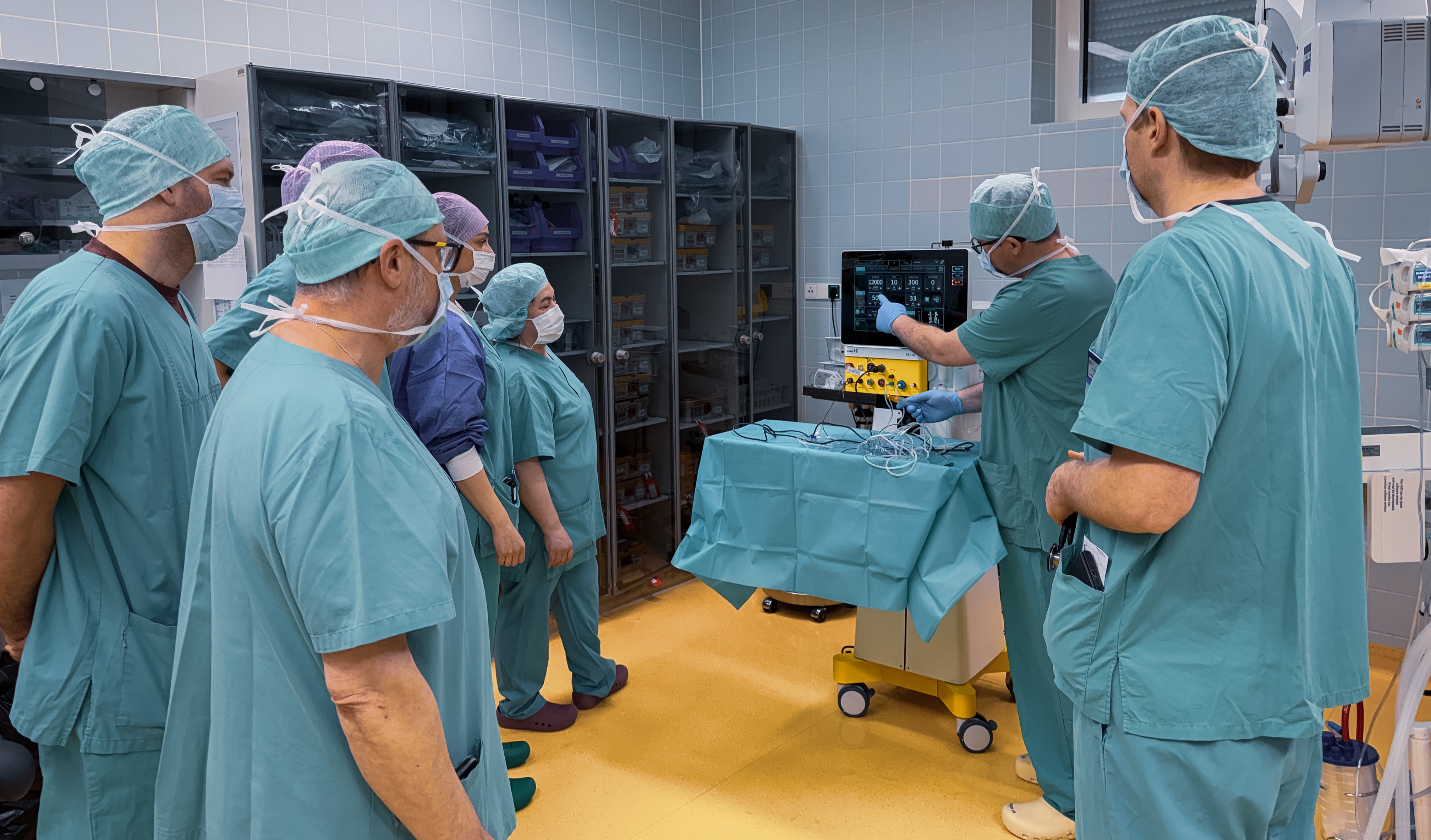 Surgical team in an operating room receiving training on the OS 4 Up surgical platform