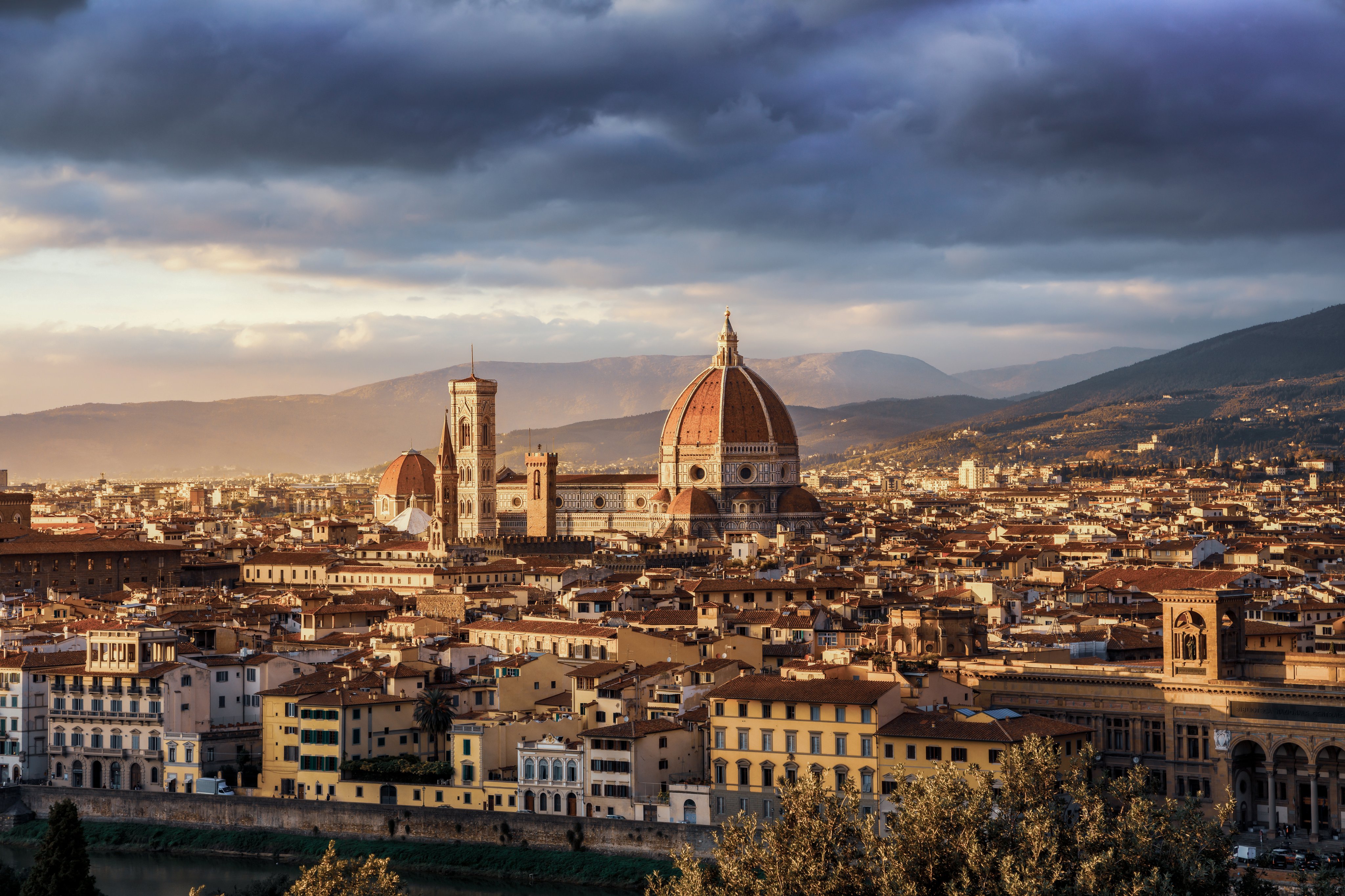 Florence skyline with the Cathedral of Santa Maria del Fiore and its dome under dramatic evening clouds