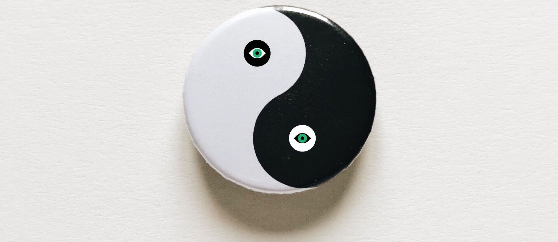 Yin-yang symbol with eye icons, representing balance, perspective and vision in eye surgery